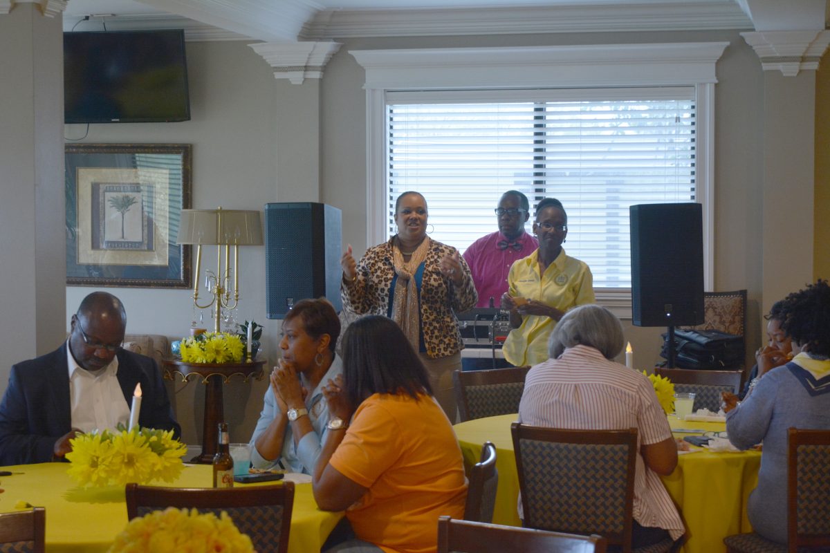 Faculty, alumni, and staff having a wonderful evening reception at the wade house on April 1st led by Brigette Rishard, the interim director of membership for the alumni federation.