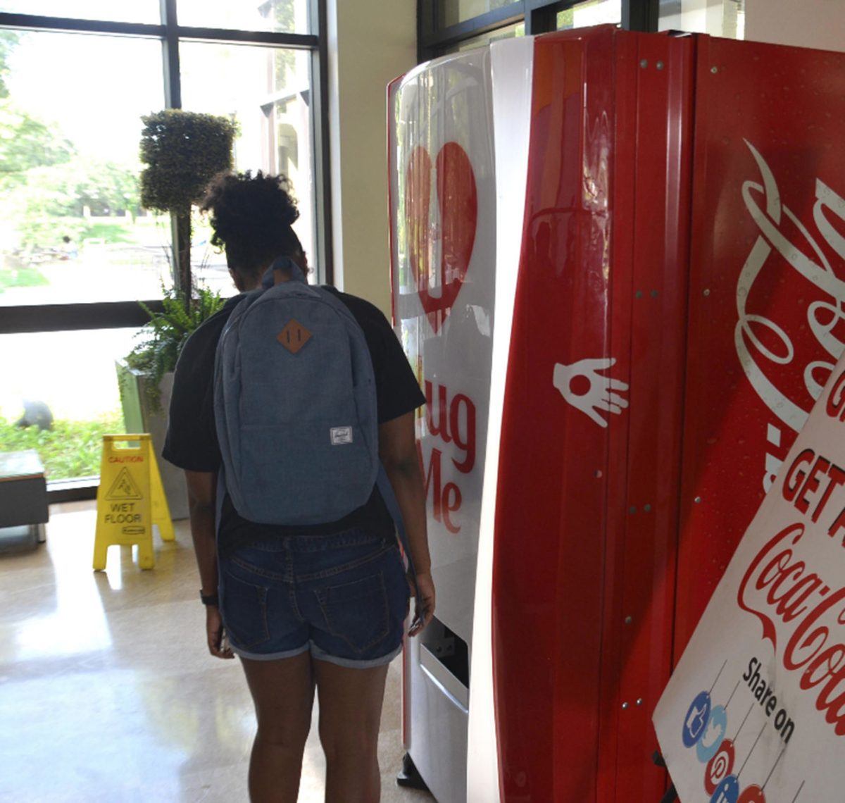 A Southern University student waits patiently for her drink to be dispensed after taking part in Coca-Colas hug machine marketing campaign currently touring colleges across the country.
&#160;