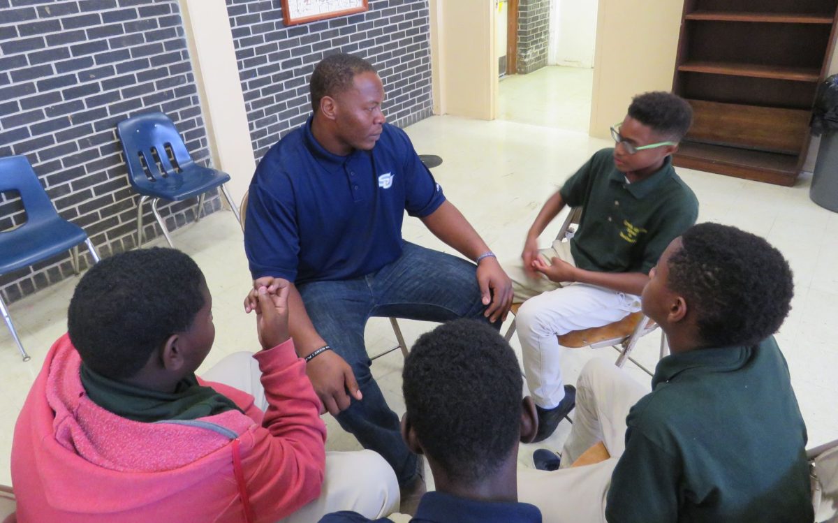 Sothern graduatue, Anthony Mosley, gives advice to grade school kids at Greenville Alternative School