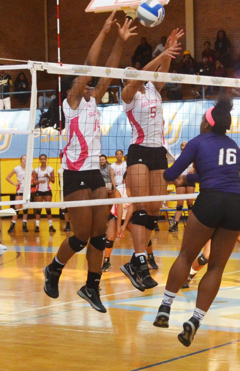 Freshman middle blocker Arabella Hall and freshman right side Brianna Hawkins block a spike against the Alcorn State Braves on October 21 in Seymour Gym.