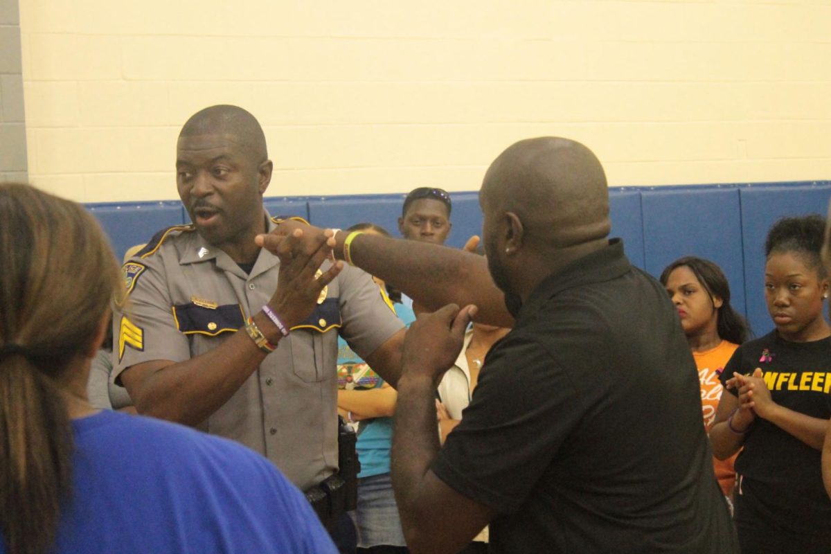 BRPD officer Sgt. Riley Harbor, III shows women the faults in standup fighting in the Intramural Complex inside the gynasium on Tuesday, October 4.