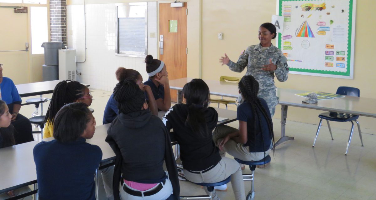 ROTC Cadet Erinn Smith gives advice to grade school chidern at Greenville Alternative School