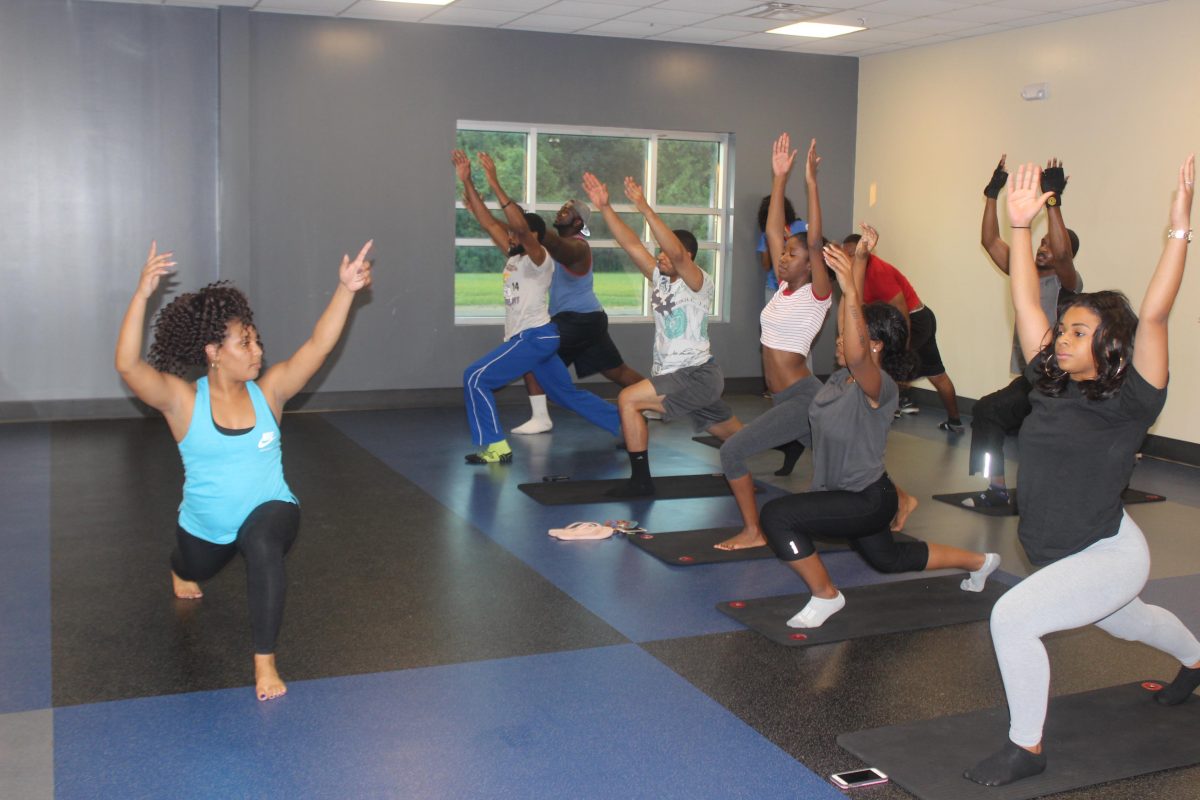 SU Alumni and Master Yoga instructor, Maya Anderson, demonstrates stretches for students during Yoga Night for Breast Cancer Awareness held in the Horace W. Moody Intramural Sports Complex on October 3.