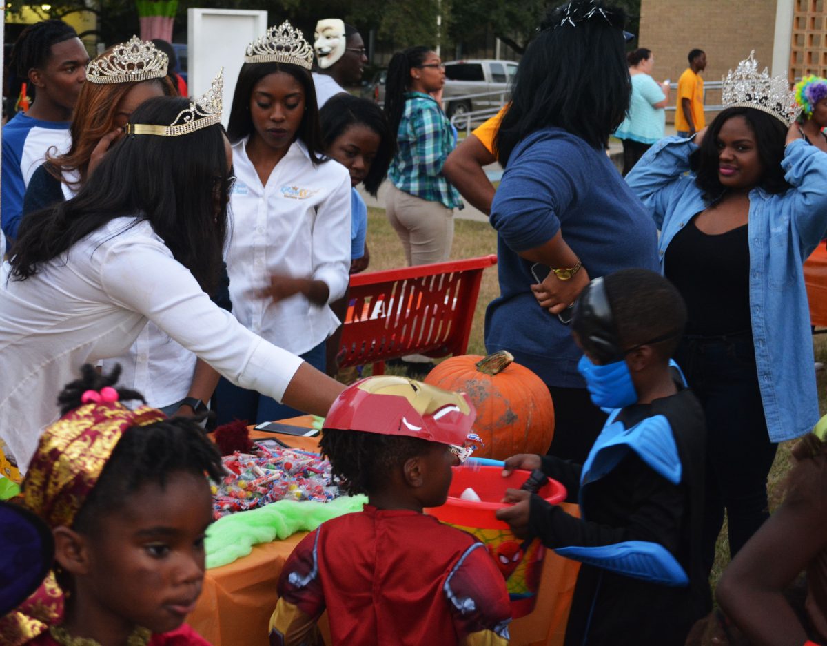 Members of the Royal Court help pass out candy to children at Boo @SU on Sunday, October 30.