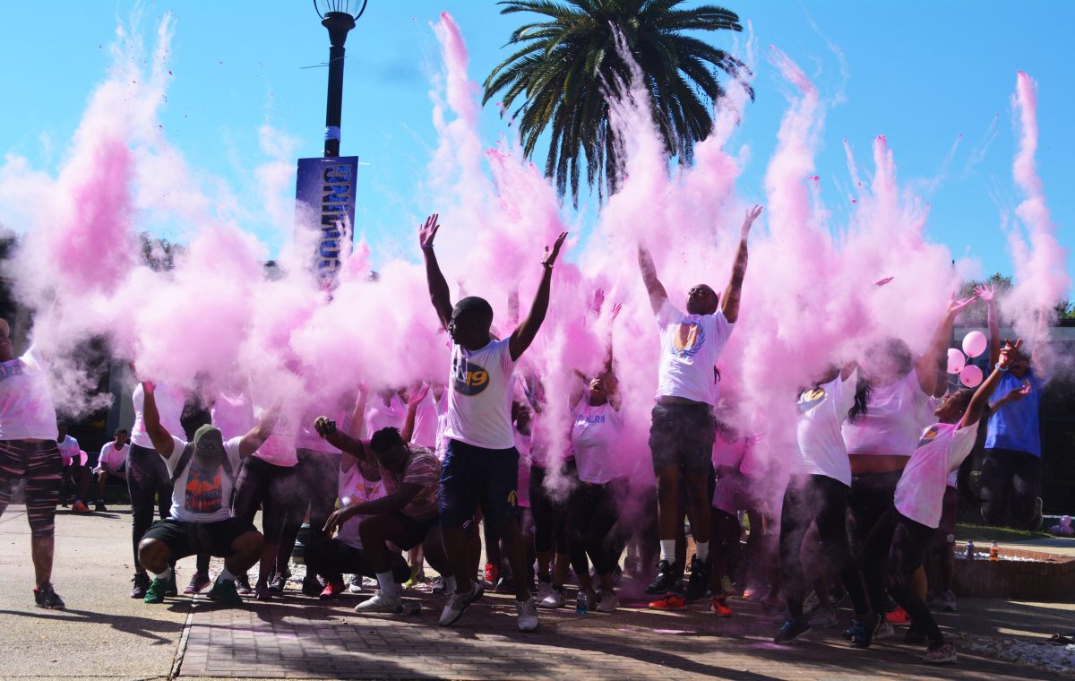 The sophmore class, along with participants celebrate a successful color run by throwing the remainder of the chalk on Sunday, October 30.