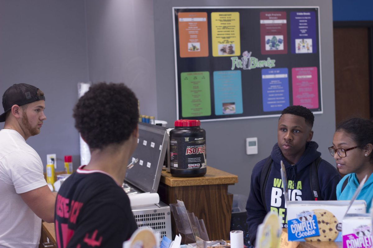 left to right: general manager Hunter Head and his employee look on as freshman electrical enginering major Trayvon Stevens and freshman biology major Tristian Joffrion make their healthy selections from the University's newest nutritional cafe, FitBlendz