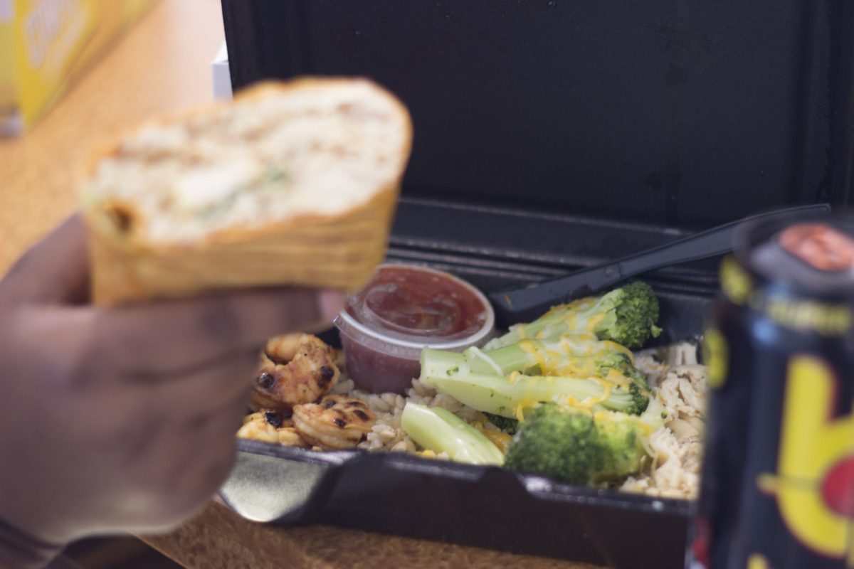 A student shows off her chicken and shrimp meal that was just ordered from FItBlends, a nutritional cafe now operating in the Intramural Sports Complex.