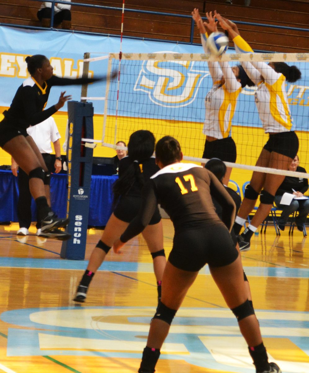 Freshman middle blocker Arabella Hall and returning junior middle blocker/ right side Bayley Neubauer block a spike against the Grambling State Tigers on October 28 in Seymour Gym.