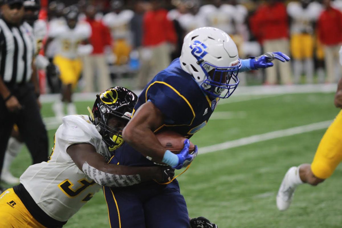 Kayla Foster/DIGEST
Senior running back, Lenard Tillery, is brought down by a Grambling defender during the 43rd Annual Bayou Classic. This year&#8217;s Bayou Classic attendance reached a record high of 67,845 fans. Grambling extended its streak against Southern to 2.