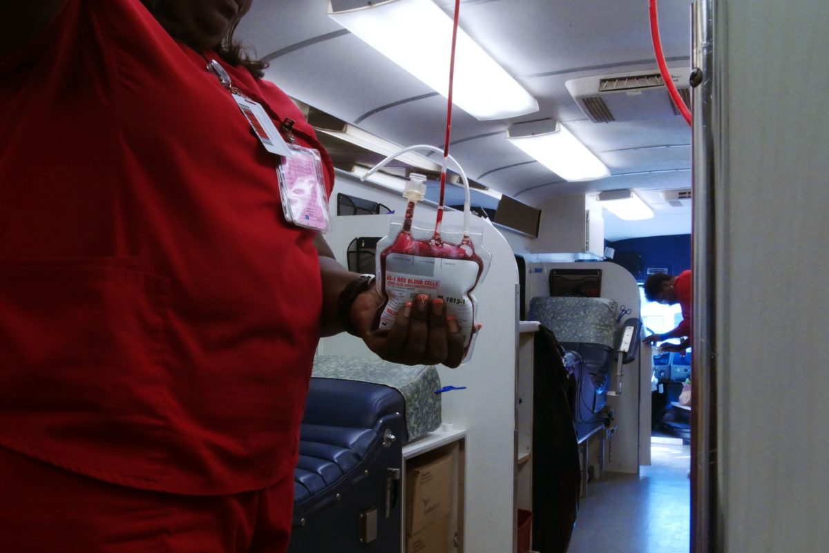 Life Share Blood Centers' Carrie James handling a pint of donated blood.