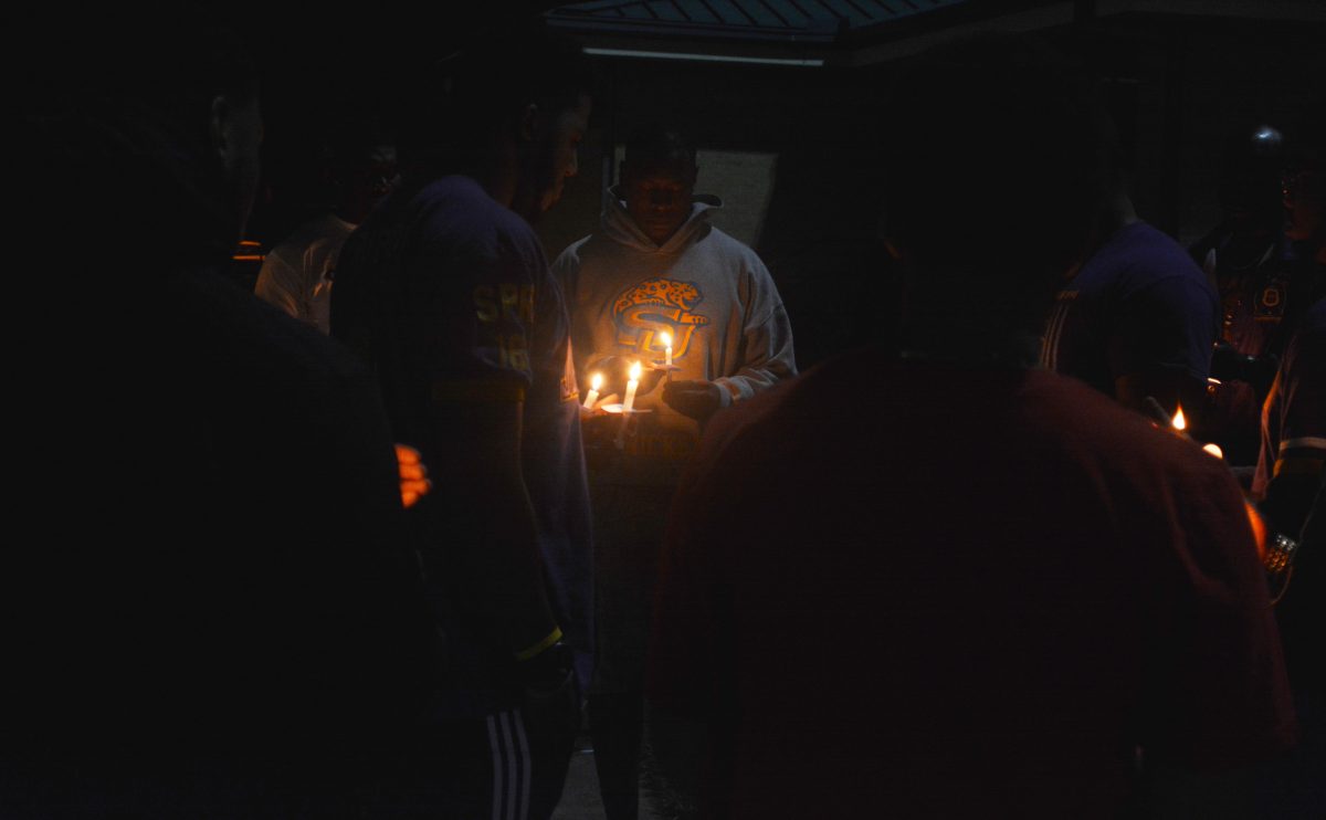 Members of Omega Psi Phi Fraternity, Inc., light a candle in honor of Founders Day, on Thursday, November 17.