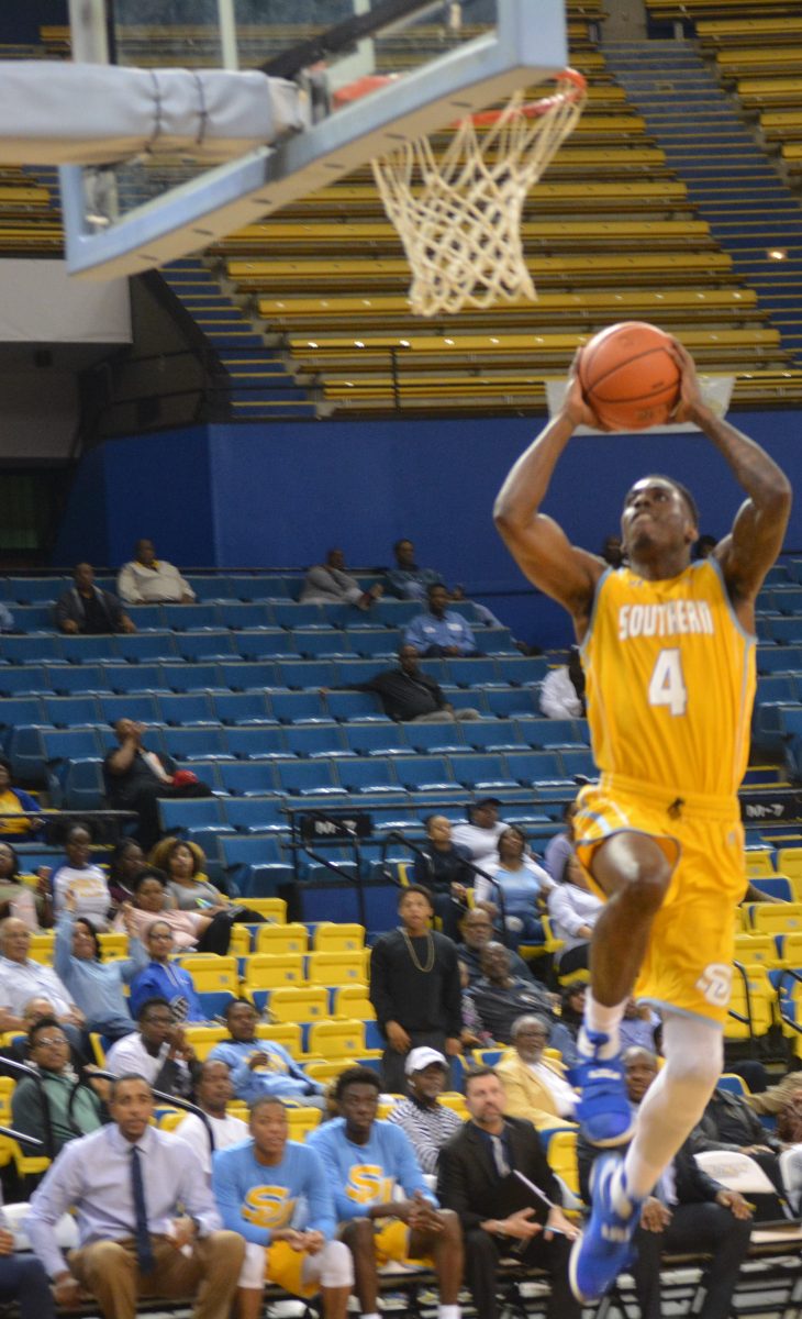 Returning Junior guard Chris Thomas goes for the slam dunk during the men's basketball game against Alabama A&amp;M on Saturday, Feburary 18, in the F.G. Clark Activity Center.