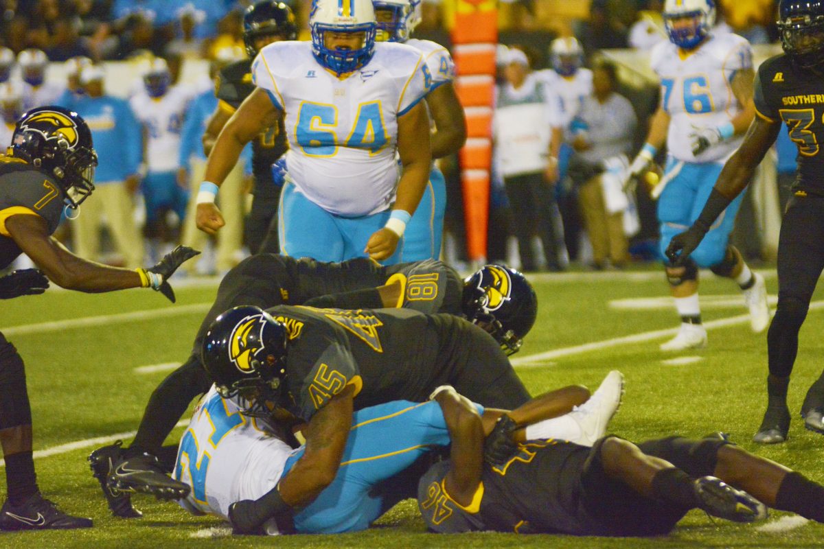 Southern Mississippi&#8217;s Derrick Dixon and Tyler Barnes take down Southern&#8217;s Herbert Edwards during the Jaguars game against the Golden Eagles on Saturday, September 9 in M.M. Roberts Stadium. &#160;JULIAN ALVAREZ/DIGEST