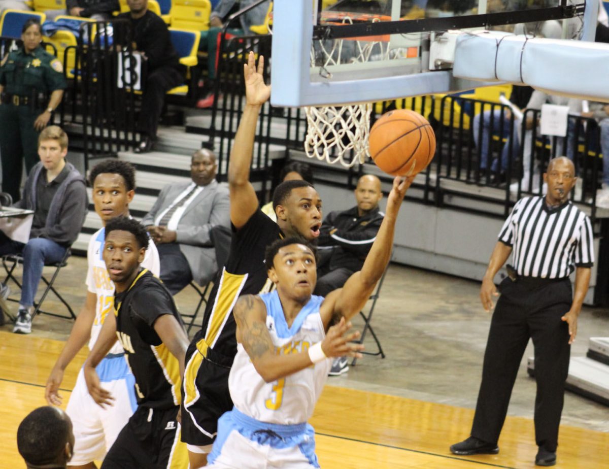 Junior guard, Eddie Reese, drives to the goal past two Alabama State defenders on Saturday, January 20 in the F.G. Activity center.&#160;