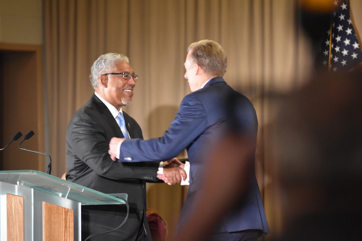 SUS President-Chancellor, Dr. Ray L. Belton shakes hands with Chairman and Chief Executive Officer of Entergy Corporation, Leo Denault, before addressing the audience at the Special Grant Announcement in the Royal Cotillion Ballroom of the Smith-Brown Memorial Union on Monday, September 10. (Courtney Jacobs/DIGEST)