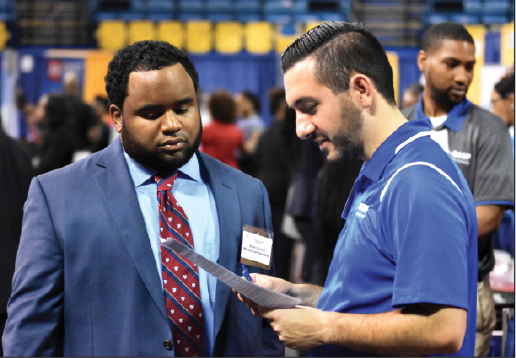 Brian Davis Jr., a mechanical engineering major, speaks with a representative from BASF Corporation, a chemical engineering company, during the 2018 Career Exploration Day inside F.G. Clark Activity Center. Courtney Jacobs/DIGEST).&#160;