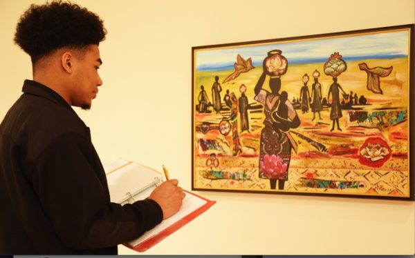Tyler Panyanouvong, a freshman engineering student from Baton Rouge, analyzes an art piece done by Malaika Favorite called “Felt in the Days” at the art gallery in Frank Hayden Hall on January 31.
