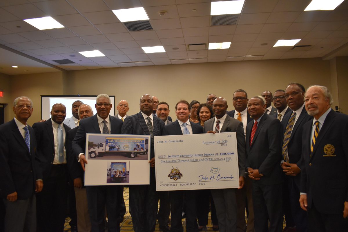 Attorney, John H. Carmouche, presents a hundred thousand dollar check to Southern University Director of Bands, Kedric Taylor to cover travel expenses for the Human Jukebox&#8217;s trip to the 2020 Rose Bowl Parade.(Tiffany Williams/DIGEST)&#160;