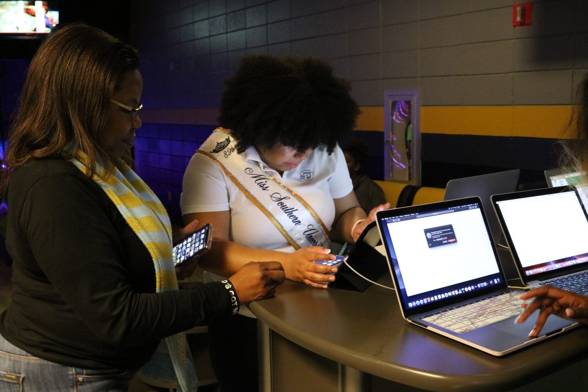 89th Miss Southern University Alacia Brew and SU Alumni Federation President, Laquitta Thomas set up computers to allow students to vote for the 2020 Ebony HBCU campus queens competition during the voting party at Jaguar Lanes on January 28. (Kyndall Jones/DIGEST)&#160;