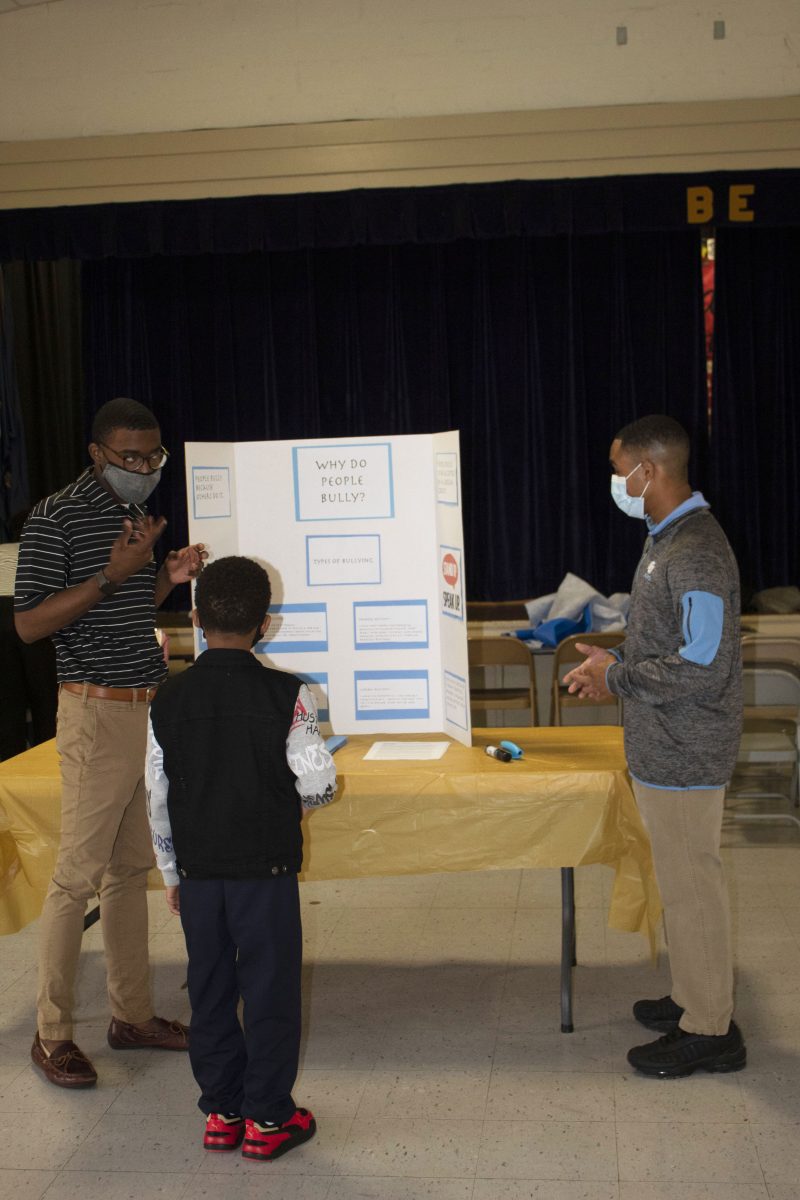 Mentees from Southern University speak to a student at the Anti-bullying Expo on April 15 at Buchanan Elementary.(Tiffany Williams/DIGEST)