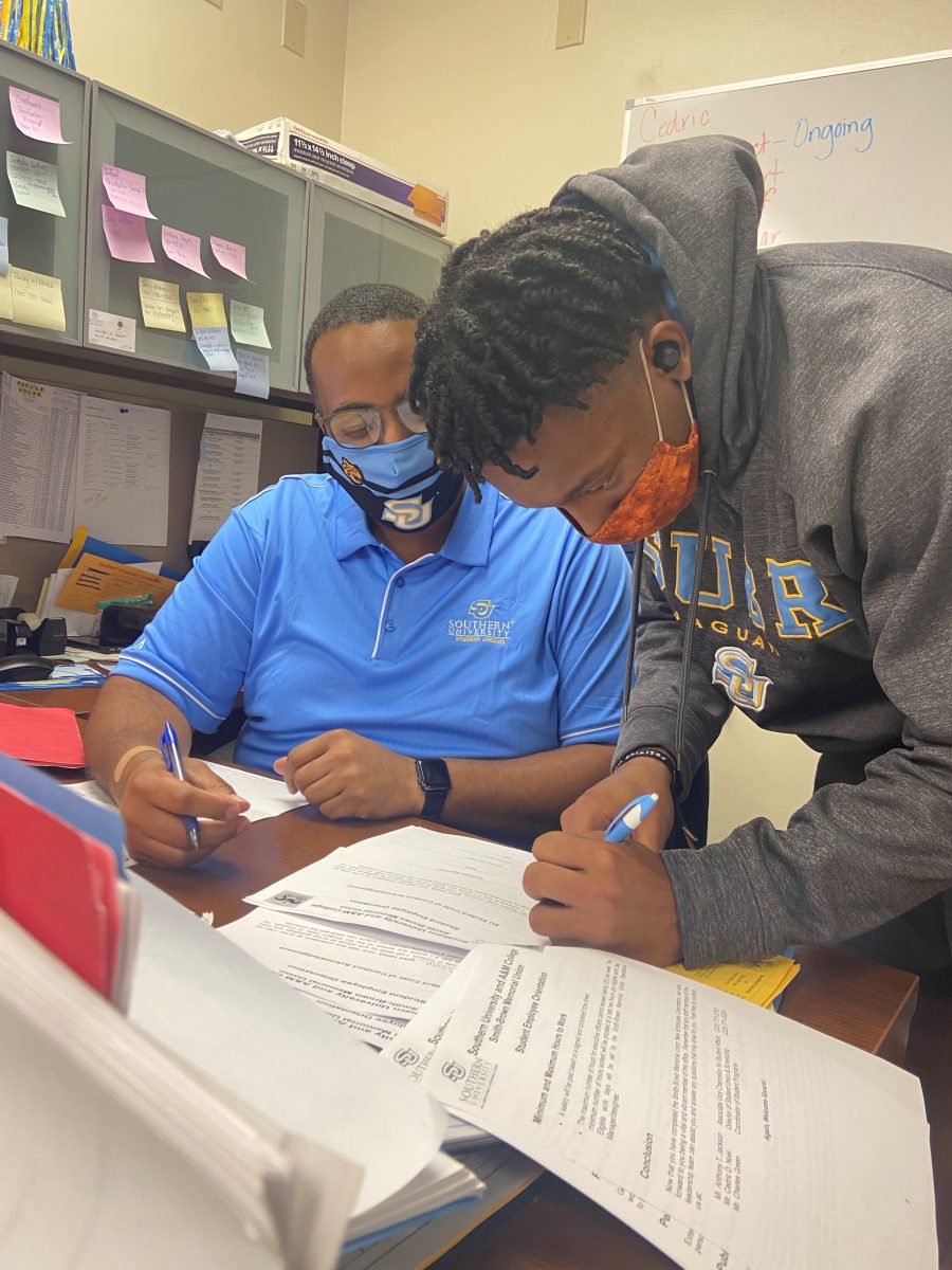 <p>Director of Smith-Brown Memorial Student Union and Events Center Cedric Noel, assist Junior Engineering major Isiah Armstrong.</p>