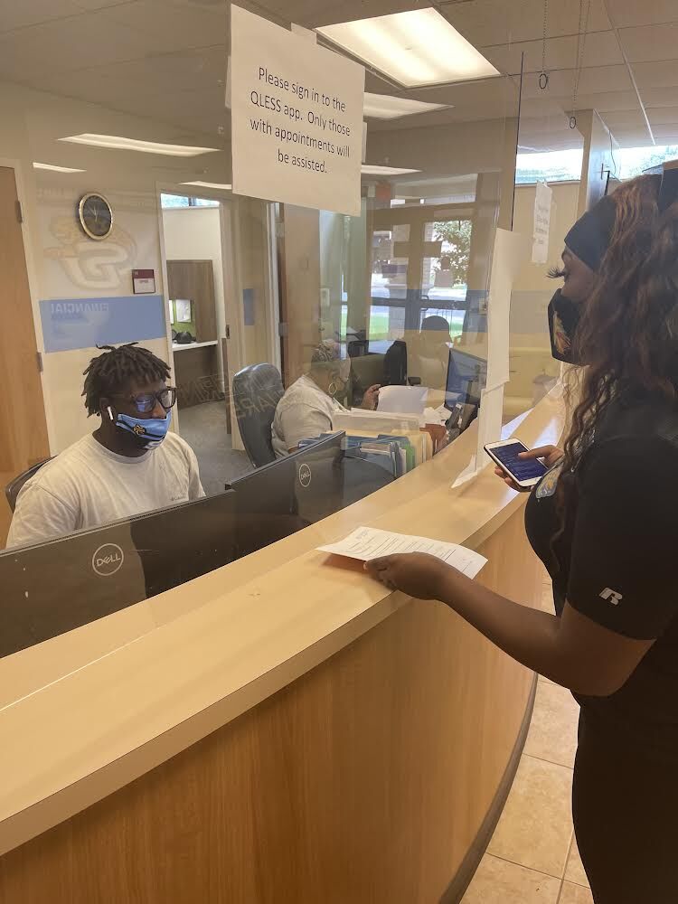 Junior, Mass Com. major Kadir Mustafo, helping out Biology major during registration in financial aid. (sydney fairbanks, aug 29,2021/ jag yearbook)