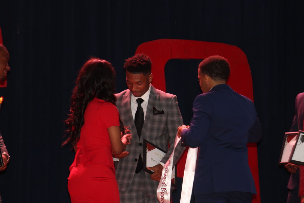 Junior, Gerald Broussard III from New Iberia being crowned 2022 Mr. Crimson &amp;Cream by former Mr.Crimson &amp; Cream Jalon Jones at the event center on April 20. (Sydney Fairbanks/DIGEST)