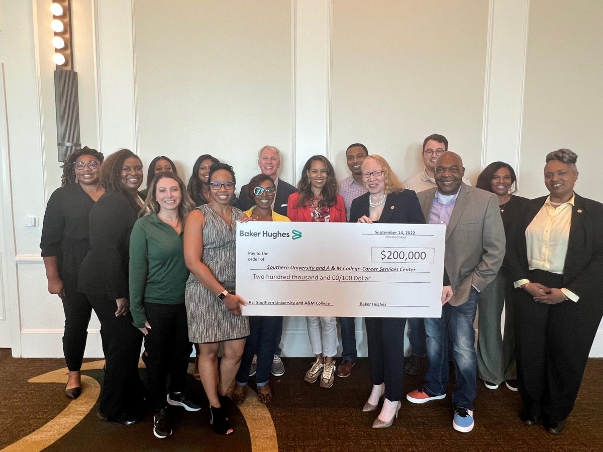 <p>Director of Career Services, Tamara Montgomery (center-right) receives a check from Corporate partner Baker Hughes on Wednesday, September 14. (Te’yanah Owens /DIGEST)</p>