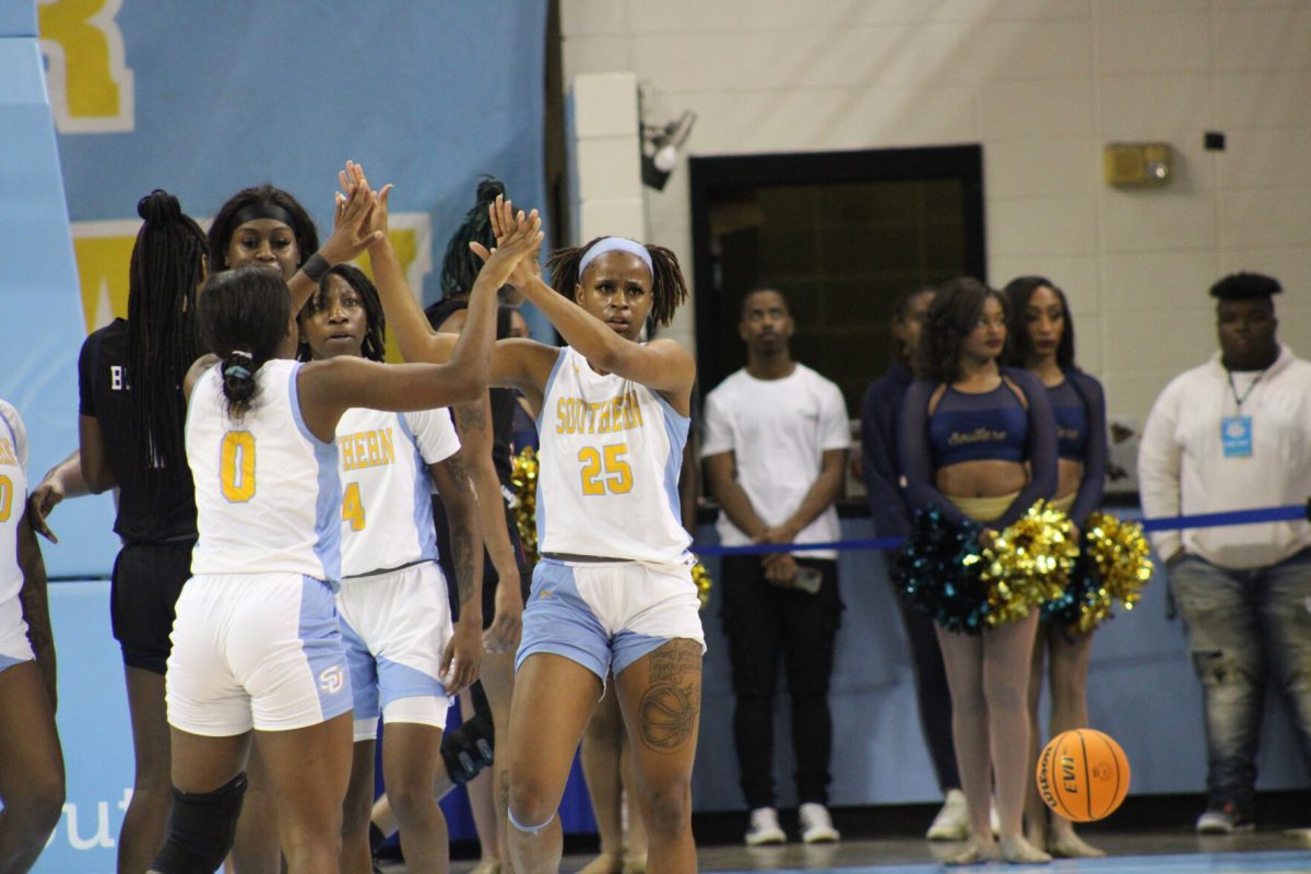 Junior Guard, Diamond Hunter gives her teammate Senior Guard, Genovea Johnson a Hi-Five after making another shot during the Jaguars game against Jackson State.
(Terren Thomas/DIGEST)