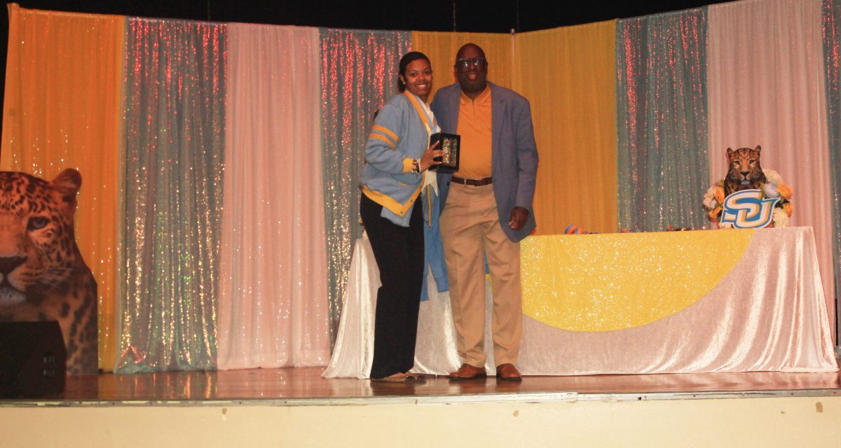 Top Jags Founder Eldred Jackson awards and takes a photo with Top Jags Advisor Tamiko Stroud, at the Achievement Dinner. (Eric White/ DIGEST)