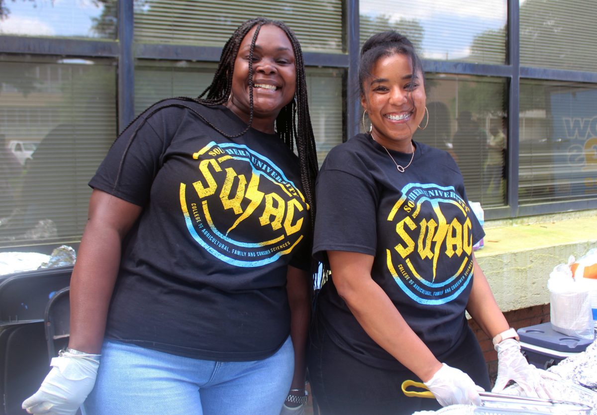 Ms. Keisha Ceaser and Ms.Saturn Douglas serving food at the Ag Day Party. (Kynedi Nichols/ DIGEST)