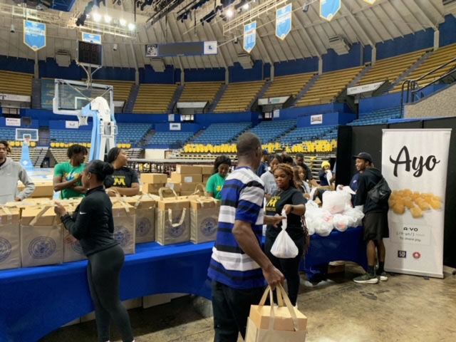 Student leaders on campus and volunteers from the community participate in handing out some donated Thanksgiving necessities in the Mini Dome on Saturday, November 18.&#160;