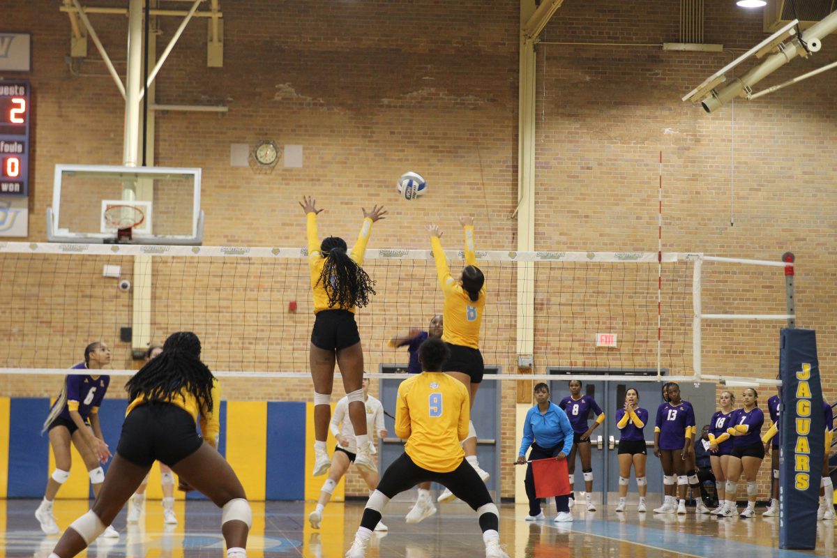 Akilah Smith and Jordan Felix spring into the air to make a block against PVAMU at the game on Monday, November 6 in Seymour Gym.&#160;