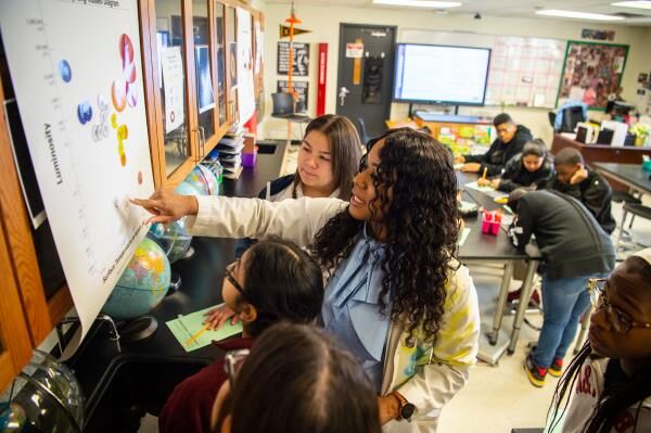 A teacher at West Dallas STEM School conducts a lesson with students.