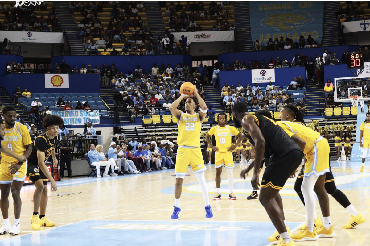 Junior, Tidjiane Dioumassi makes a free thow shot after being pushed to the ground during the Southern vs. Grambling basketball game on Saturday.