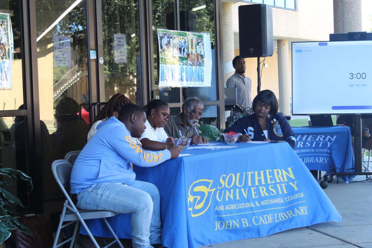 Judges at the 6th annual John. B Cade poetry slam tallying points on October 17. 