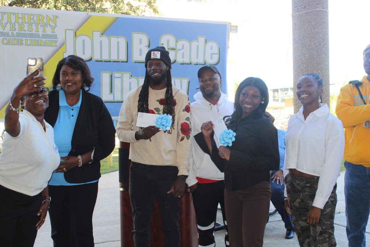 The winners of the Poetry Slam hosted by the John B. Cade Library pose for a photo on October 17.