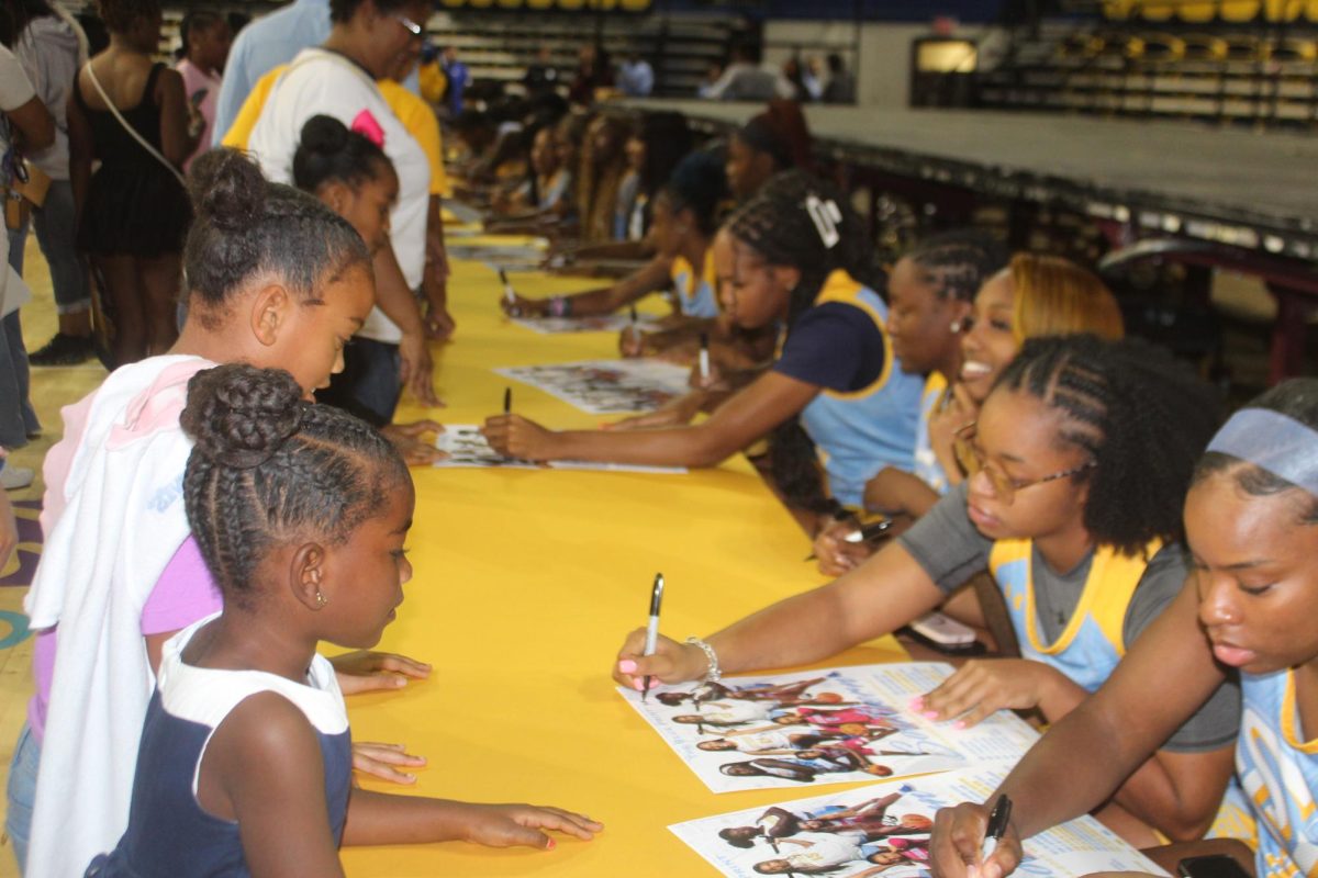 The Jaguar Women's basketball team signing poster at the 2024 Jaguar Pandemonium Day inside the F.G. Activity Center on Sunday, October 20.