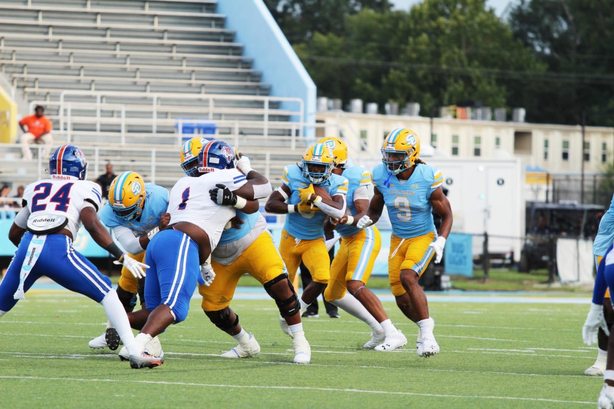 Sophomore, running back, Kendric Rhymes muscles through the gap with a key block  from the offensive line during the Pete Richardson Classic.