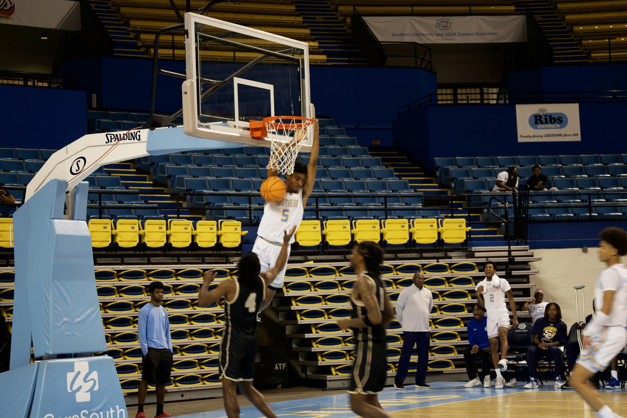 Freshman guard, Jayce Depron, dunks on Royal defenders after making a steal.  
