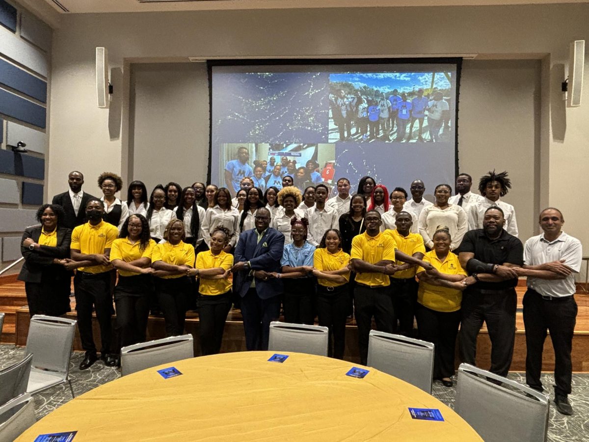 Members of MANRR, their advisors, and Dr. Orlando McMeans (center), pose for a photo with newly pinned members after their ceremony on Tuesday, February 11. 