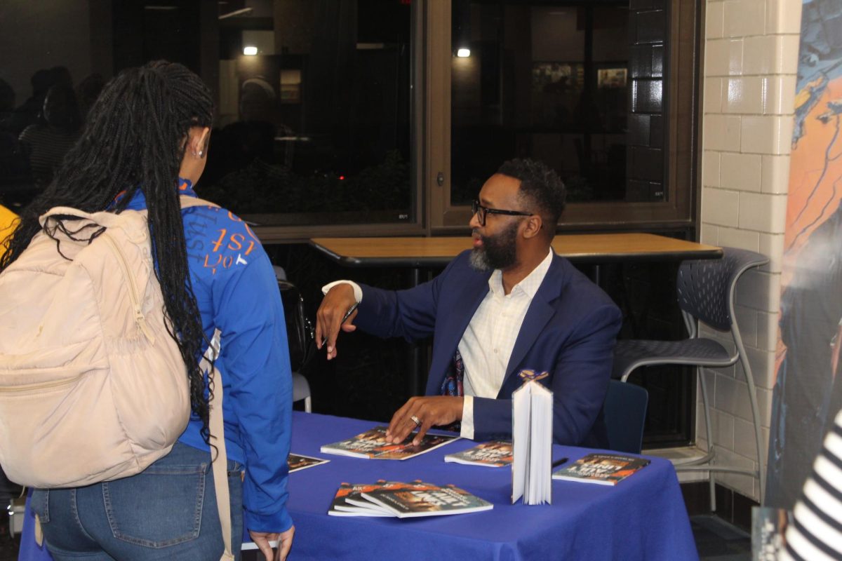 Author, Frank Jones, III signing books  and having small chat with students.