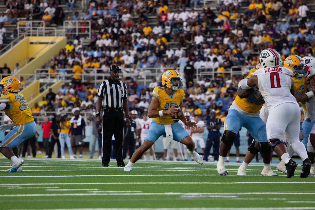 Junion, quarterback, Ashton Strother  drops back in the pocket a pass during the BoomBox Classic on Saturday, September 27.