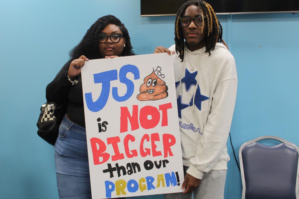 Sophomore, Sydni Smith and Willi Nelson hold their sign at the Poster and Clear Bag Making event hosted in the Mocha Room on September 4.