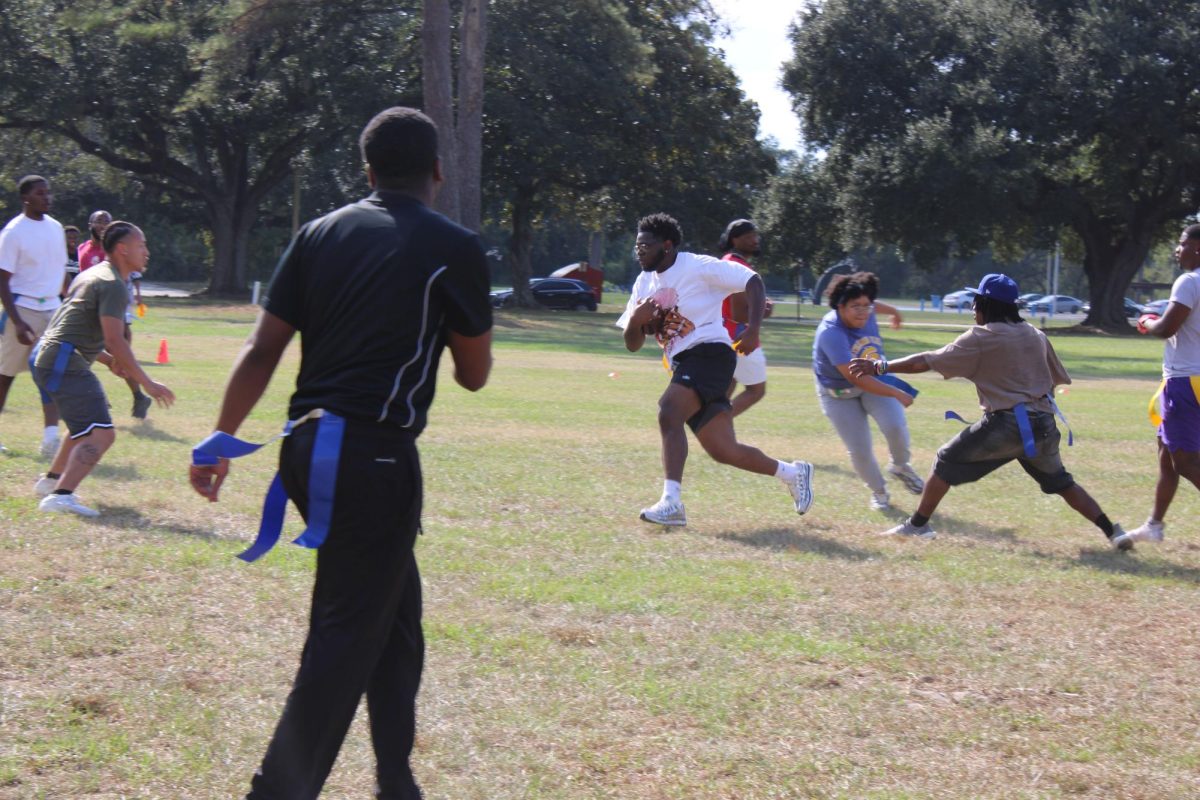 Students engage in a Powder Puff football game at the Game Day Groove event hosted by the Association for Women Students and Men's Federation on October 2 hosted on the Rec Lawn. 