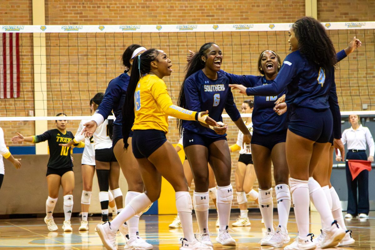 The team gathers and celebrates them winning a point in the 3rd set against Grambling at Seymour Gym on Monday, November 10.