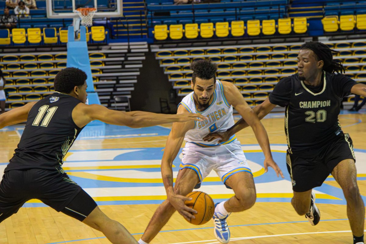 #8 Forward Malek Abdelgowad drives the ball to the basketball down the lane against Champion Baptist College on Saturday, November 15 in the F.G. Clark Activity Center.